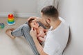 Fathers Day holiday. Proud Caucasian father playing with newborn baby girl. Parent holding rocking cute funny child daughter son. Royalty Free Stock Photo