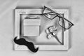 Fathers day. Homemade gift box, the symbols of Father`s Day-glasses, mustaches, roses. CONCEPT congratulation AND GIFTS. Composit
