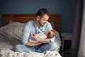 Fathers Day. Middle age Caucasian father with sleeping newborn baby girl. Parent holding child daughter son on hands. Authentic Royalty Free Stock Photo