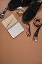 Fathers Day mockup with pen, perfume, belt, footwear, notepad and eyeglasses on brown background. Set of stylish male clothes and Royalty Free Stock Photo