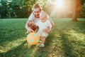 Fathers Day. Young father playing ball with toddler baby boy outdoors. Parent spending time together with child son in park. Royalty Free Stock Photo