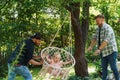 Fathers swinging their daughter on a hammock chair