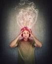 Fatigue and annoyed man, feels like mind is boiling as dense steam comes out of his head. Brain burning and mental explosion with Royalty Free Stock Photo