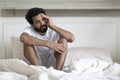 Fatigue Concept. Tired Young Indian Man Sitting In Bed At Home Royalty Free Stock Photo