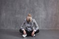 Fatigue, professional burnout. Young woman in business suit sitting in Lotus pose, head down