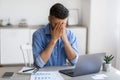 Fatigue From Work. Stressed male entrepreneur covering face with hands at workplace Royalty Free Stock Photo