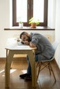 Tired exhausted man with beard sleeping on table in office Royalty Free Stock Photo