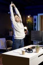 Fatigued cybersecurity specialist stretching after coding all day