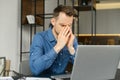 Fatigued guy using laptop for working Royalty Free Stock Photo