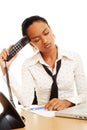 Fatigued woman with telephone Royalty Free Stock Photo