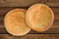 Fatir, uzbek flatbread on old wooden background top view