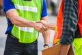 Fatory worker handshake with blurred construction site, Success and Teamwork concept Royalty Free Stock Photo