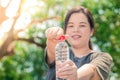 Fatty asian white girl hold clean water bottle