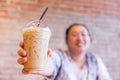Fatty asian women smile with ice cool milk coffee drink