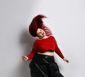 Fatty redhead model in red spiked top, black skirt. Smiling, dancing, shaking hair, posing  on white photo background Royalty Free Stock Photo