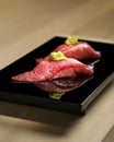 Fatty Tuna Sushi fillet with wasabi on black platter Royalty Free Stock Photo