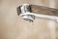 Faucet with dripping water. Tap closeup with dripping water-drop. Water leaking, saving concept Royalty Free Stock Photo