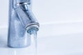 Faucet flowing water and with limescale. Detail of dirty and calcified bathroom taps