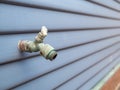 Faucet for garden hose attachment outside of house, rusty worn Royalty Free Stock Photo