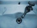 Faucet of an old and deteriorated washbasin Royalty Free Stock Photo