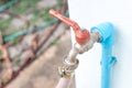 Faucet old red plumbing. Brass water tap in nature background. Water valve in the garden Royalty Free Stock Photo