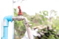 Faucet old red plumbing. Brass water tap in nature background. Water valve in the garden Royalty Free Stock Photo