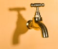 Faucet in orange wall Royalty Free Stock Photo