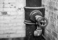 Faucet and pipe in old mill in black and white