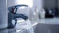 Faucet with running water, close-up, blurred background. Royalty Free Stock Photo