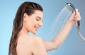Faucet, shower and woman with water for cleaning, skincare and body care in studio on blue background. Wellness