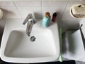 Faucet with soap in a bathroom, washing hands concept