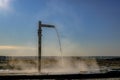 A faucet with warm water flowing to the ground on a frosty day Royalty Free Stock Photo