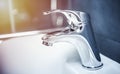 Faucet and water drop close up. Bathroom interior with sink and water tap. Royalty Free Stock Photo