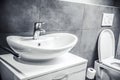 Faucet and water drop close up. Bathroom interior with sink and water tap. Royalty Free Stock Photo