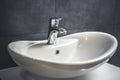 Faucet and water drop close up. Bathroom interior with sink and water tap. Royalty Free Stock Photo