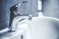 Faucet and water drop close up. Bathroom interior with sink and water tap. Royalty Free Stock Photo