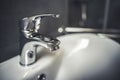 Faucet and water drop close up. Bathroom interior with sink and water tap. Royalty Free Stock Photo