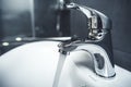 Faucet and water drop close up. Bathroom interior with sink and water tap. Royalty Free Stock Photo