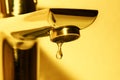 Faucet and water drop in golden toned Royalty Free Stock Photo