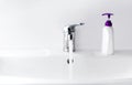 Faucet, water flow, and sanitizer. Antiseptic dispensers near water tap sink with faucet, washing hands with soap to protect from Royalty Free Stock Photo