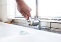 Faucet, wrench and plumber hand, plumbing and maintenance for kitchen sink, trade and manual labour. Person fixing tap Royalty Free Stock Photo