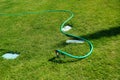 Faucets and green hoses are in the garden, lawn irrigation