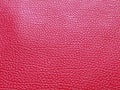 Faux red leather. Separate grooves and elevations on the surface of a bag or shoe. Reflection of the light. Fashion accessory made