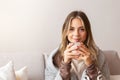 Serene girl enjoying hot coffee at home