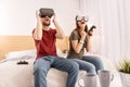 Excited vigorous couple emulating in VR headsets