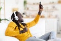 Favorite Leisure. Black Guy Dancing While Listening Music On Smartphone At Home Royalty Free Stock Photo