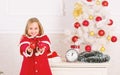 Favorite part decorating. Getting child involved decorating. How to decorate christmas tree with kid. Girl smiling face Royalty Free Stock Photo