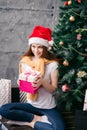 Favourite holiday , girl is going to put the gift under the tree Royalty Free Stock Photo