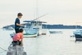 Fazana, Croatia - June 1, 2019: two little boys fishing at sea wooden pier. sea dock Royalty Free Stock Photo
