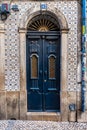 FaÃÂ§ade with a blue wooden door and azulejo tiles in the centre of Lisbon, Portugal